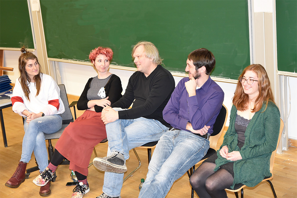 Die fünfr Referenten sitzen nebeneinander vor einer Tafel.