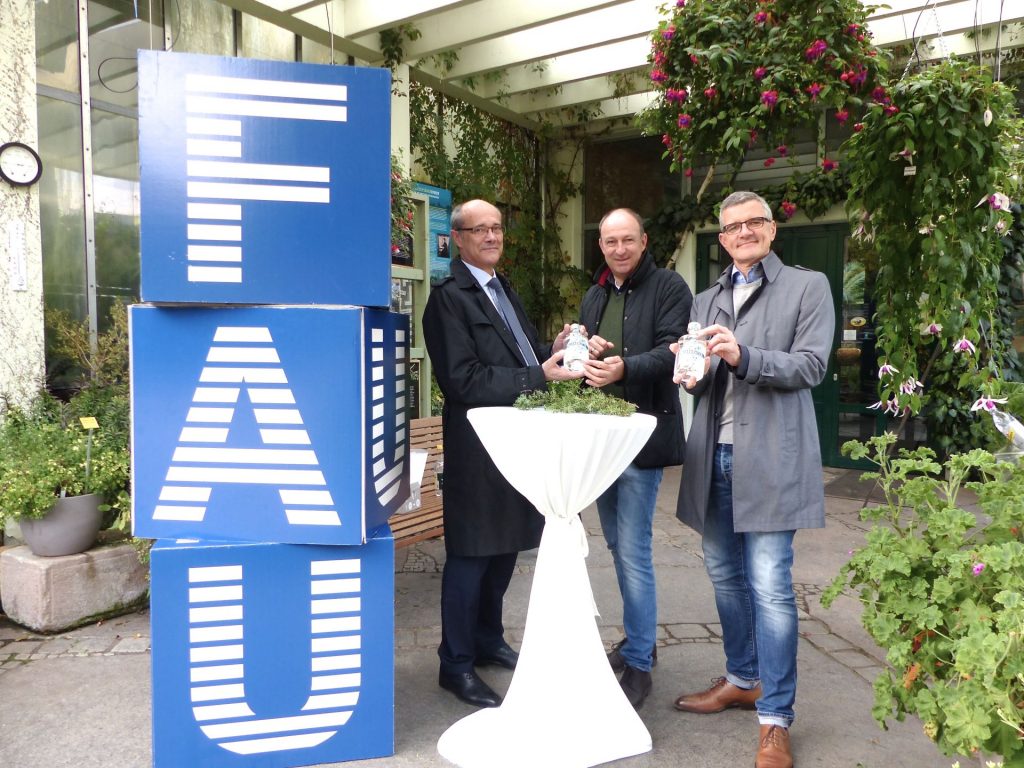 Drei Personen an Stehtisch im Botanischen Garten