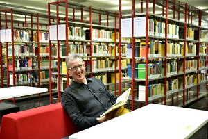 Man with book in a liberary