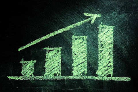 Business chart on blackboard showing increase in sales