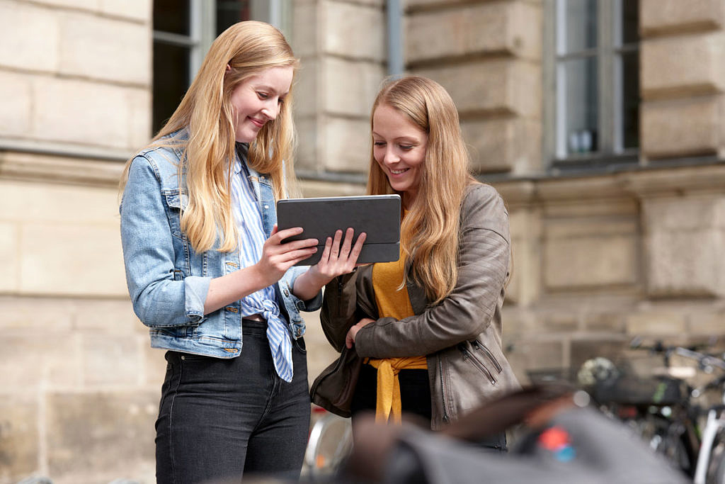 Female students with a tablet.
