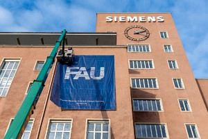 FAU flags are placed on the building.