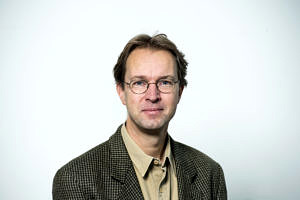 A man in front of a white background.