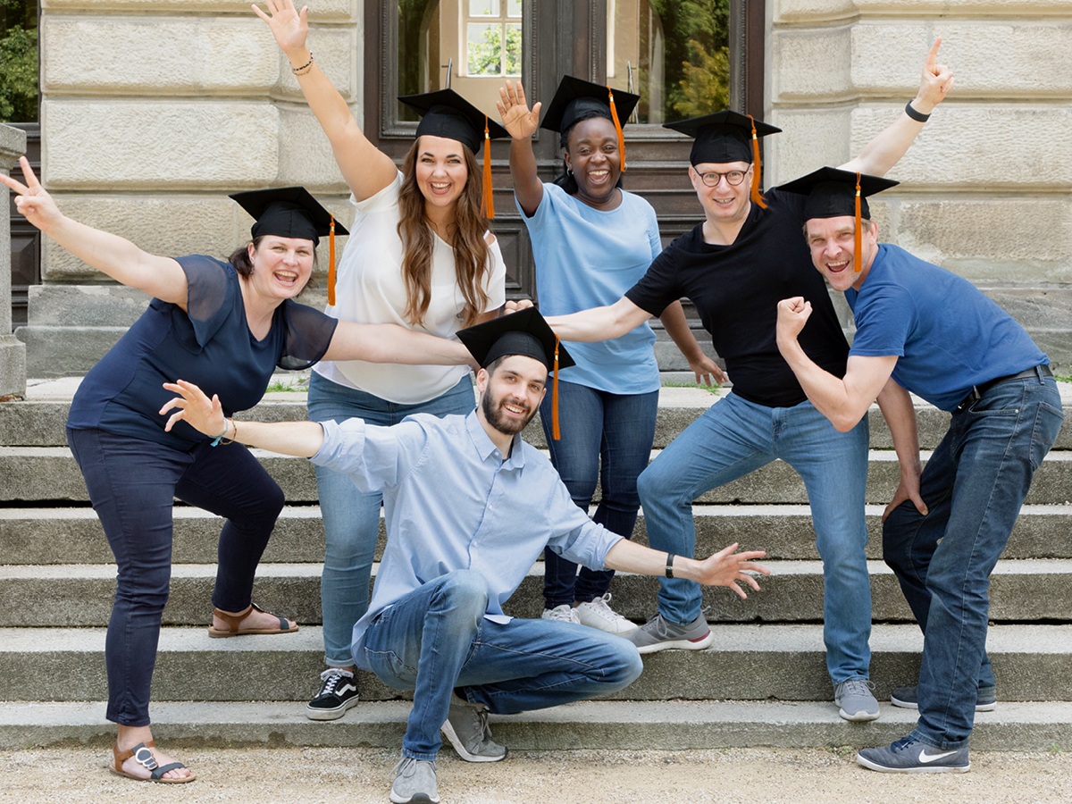 A group of happy people wearing graduation caps