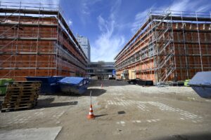 The image shows a building site with two buildings.