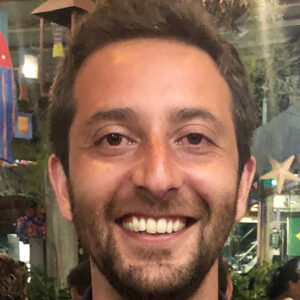 A man smiles into the camera.