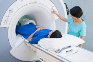 Technisch-medizinische Assistentin bringt Patientin in Position für MRT-Scan