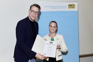 Dr. Jennifer Munkert vom Department Biologie der Friedrich-Alexander-Universität Erlangen-Nürnberg und Wissenschaftsminister Markus Blume