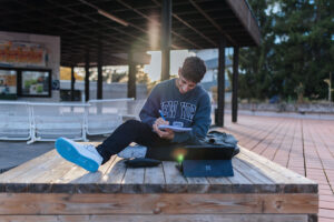 FAU student in front of FAU building