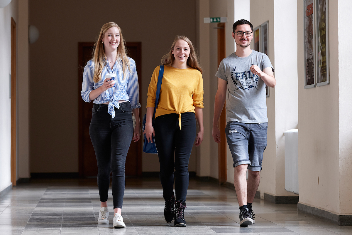 Studierende laufen durch Kollegienhaus