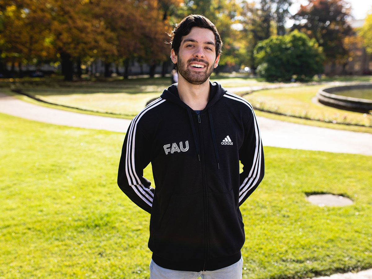 Student trägt FAU-Hoodie