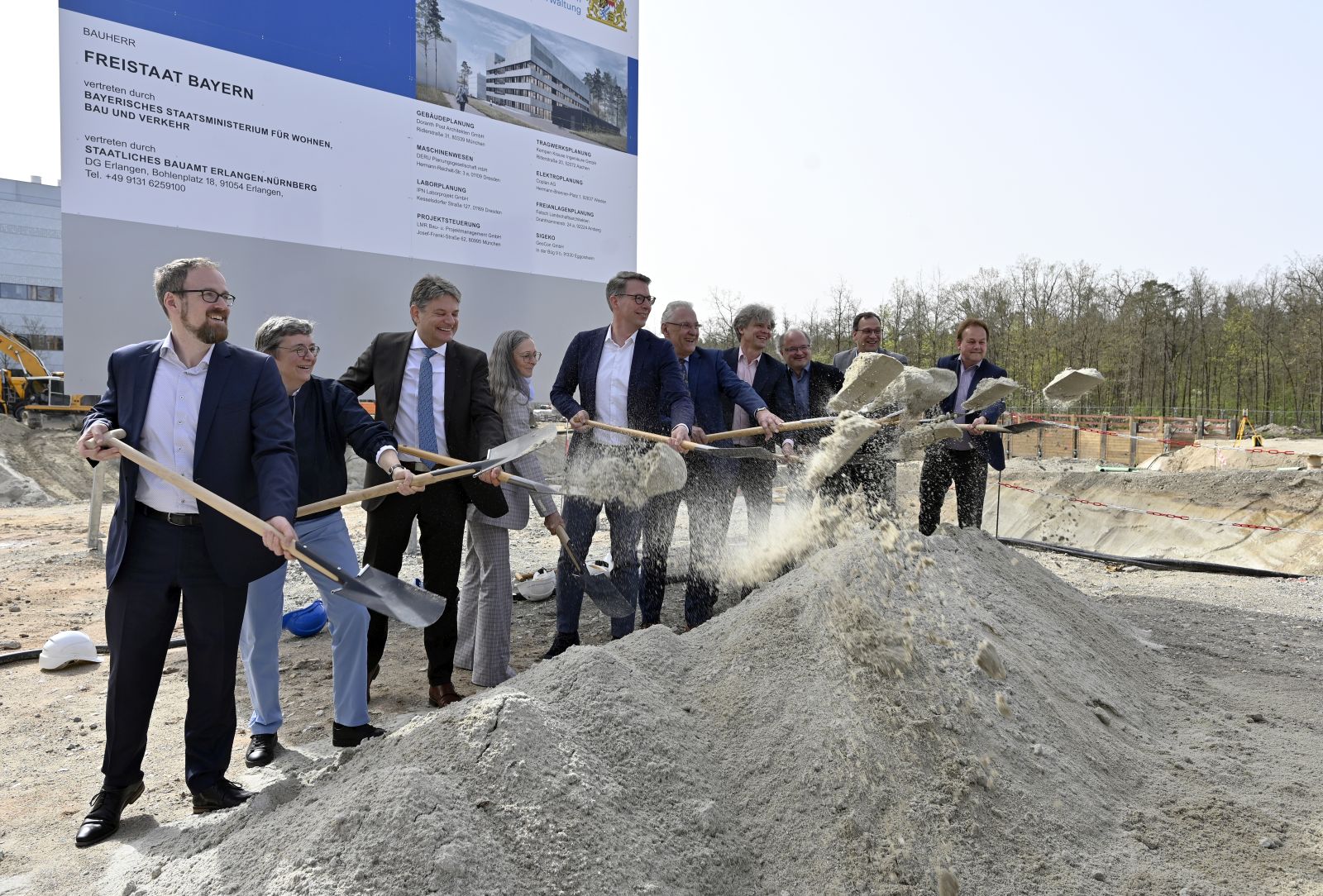 Menschen mit Spaten beim Spatenstich auf dem Baufeld des Neubaus der Technischen Chemie der Friedrich-Alexander-Universität Erlangen-Nürnberg in Erlangen