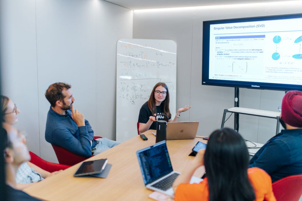 Dozentin spricht zu einer Gruppe Studierende