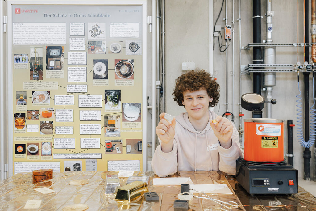 Emil Dreyer presents two lumps of gold and silver at his stand that he extracted from old gold teeth.