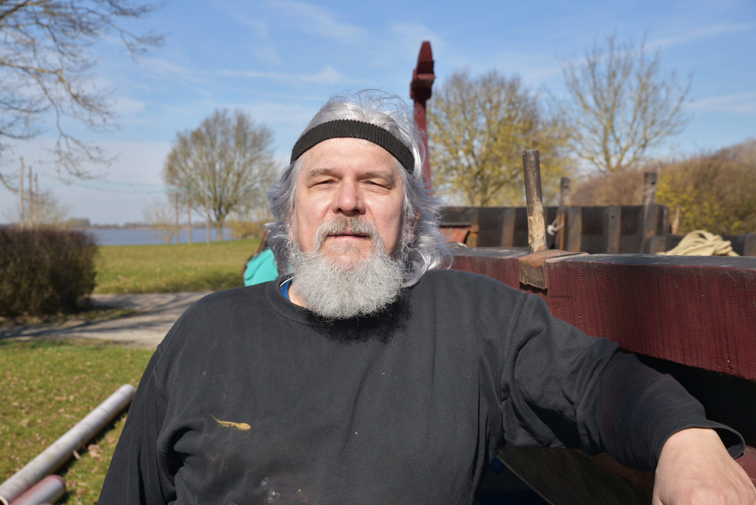 Dr. Marcus Speck, a sturdy man with long, gray hair. 